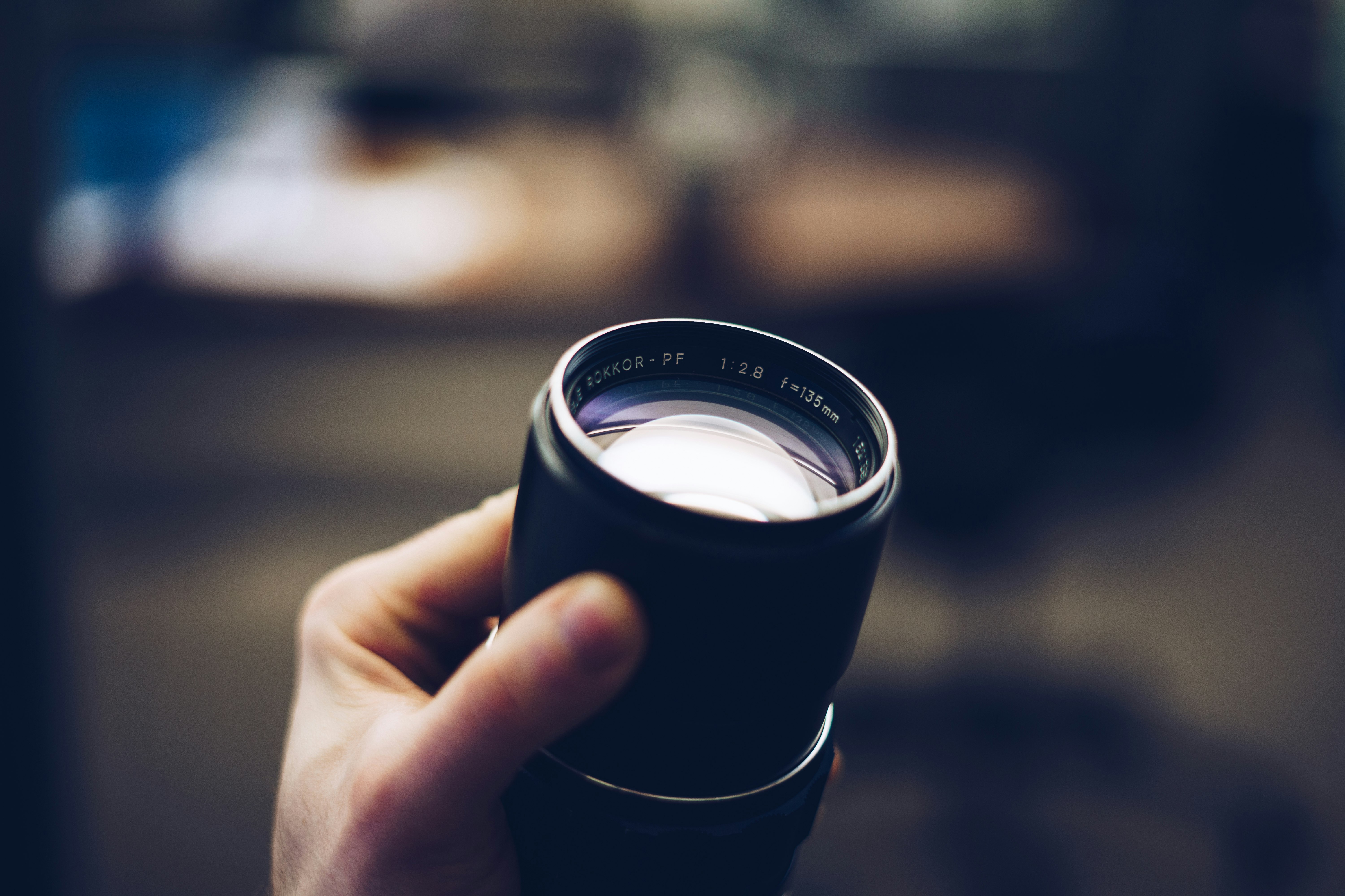 person holding black camera lens